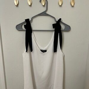 Elegant White Top with Black Bow Accents
